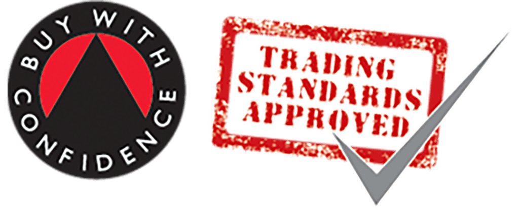 The image shows the "Buy With Confidence" logo, featuring a black circle with white text and a central red peak. Next to it is a red stamp-like graphic with "Trading Standards Approved" written in white, accompanied by a large gray checkmark.